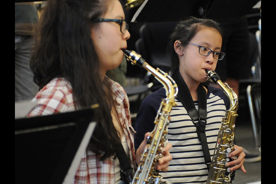 Saxophone players Grace Ng and Keala Leung concentrate on their parts. Photo: Dan Toulgoet