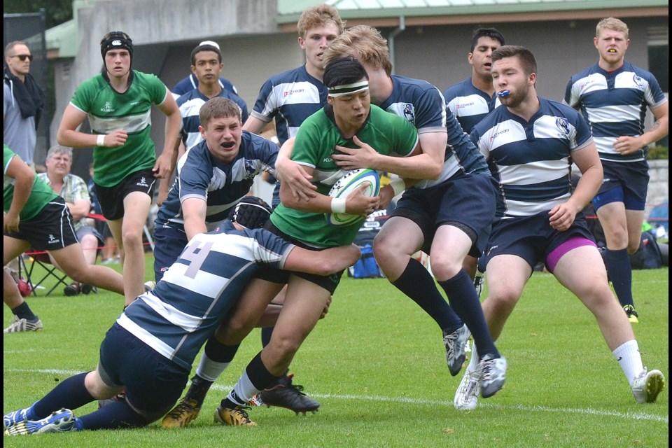 Kevin Wu battles his way up field during McRoberts 25-20 win over GW Graham Saturday to open the B.C. AA Rugby Championships