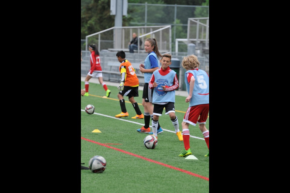 Chung Chow photo Danone Nations Cup Training Camp at Burnaby Lake Sports Complex - West Niko Sigur from Burnaby being put through his paces.