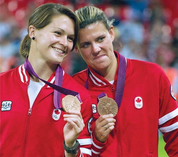 Erin McLeod and Christine Sinclair display their bronze medals following a win over France at the 2012 Olympic Summer Games.