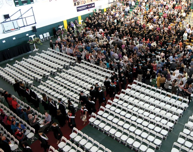 Graduates file down the aisle to their seats during Ceremony 1 of the 2015 University of Northern BC Convocation Friday at the Charles Jago Northern Sport Centre.
