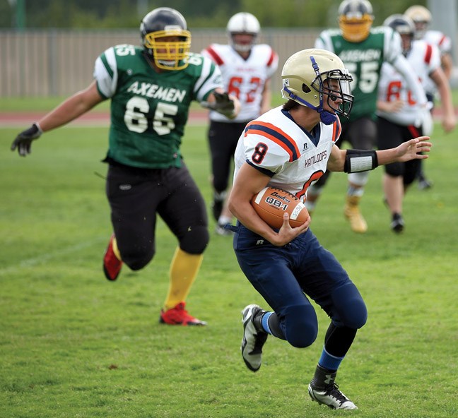 Jayden Mourato runs with the ball as the Interior Select team (white) took on the North Stars (green) in the Two Rivers All-Star football game Saturday at Masich Place Stadium. The game consisted of players from Grade 10 and 11 from Northern BC against the top players from the Interior.