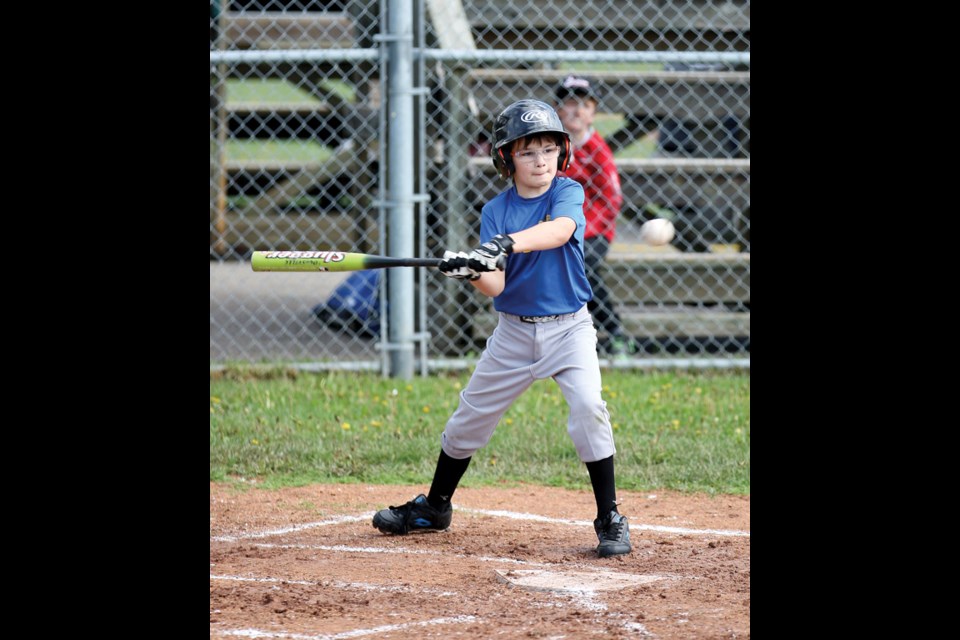Blaise Willson focuses on the ball as he takes a swing as his Team No. 2 (blue) takes on Team No. 5 (orange) in Saturday morning's Tadpoles division game as part of the Prince George Youth Baseball Family Fun Day.