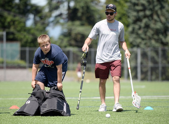 Helping hand: New Westminster Senior Salmonbellie Patrick Miles gives a hand to a youngster taking in some off-the-floor fun.