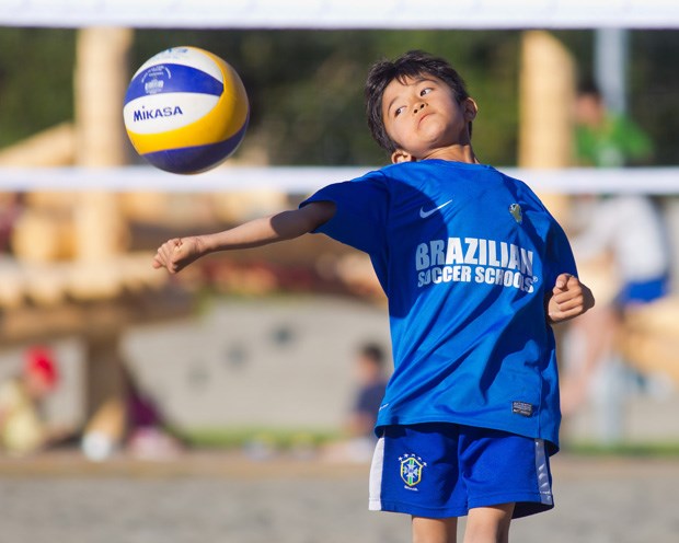 A young child plays beach volleyball at the Richmond Olympic Oval. Gord Goble photo.