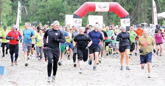 Runners are all smiles as they start the Mudd Sweat and Tears obstacle course at Otway Nordic Center this past Saturday. Roughly 1300 people participated in the first time event that saw an 8km course wind its way around the facility and featured obstacles such as walls, barbed wire crawls and rope climbing.