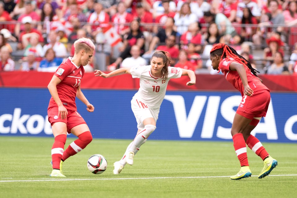Canada's Sophie Schmidt (left) and Kadeisha Buchanan guard the ball from Swiss striker Ramona Bachmann in a 1-0 Canada victory in the knock-out stage of the World Cup at B.C. Place June 21, 2015. Photo Canada Soccer Association