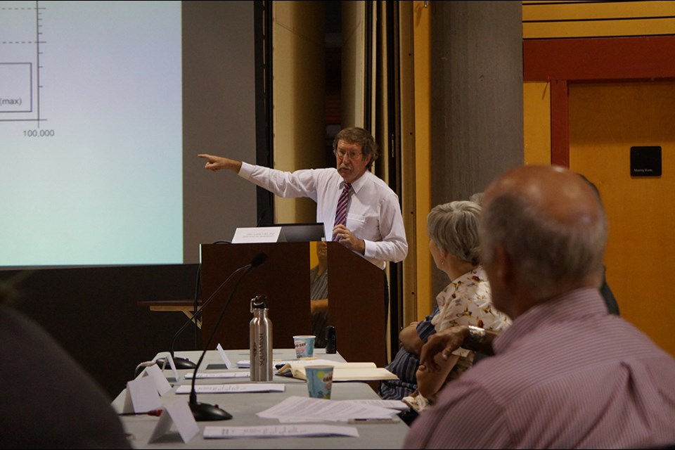 Geologist and professor John Claque presents to the joint committee of the whole meeting at Totem Hall on Tuesday. The report Claque presented offered suggestions of risk criteria the district could use to assess next steps in the mitigation of the landslide risk on the Cheekye Fan.