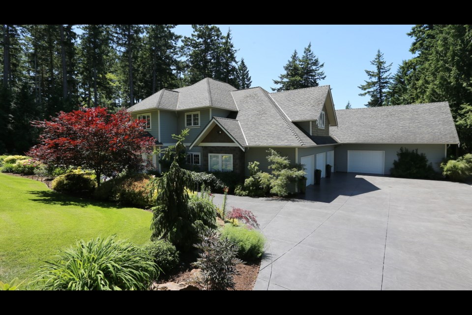The North Saanich home is situated on almost half a hectare and has an enormous back patio and large waterfall and pool.