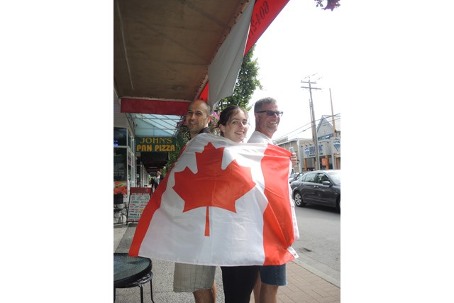 Bean and Beyond Cafe’s Davood Khatami, left, and Lucy Sharples, centre, get into the Canada Day spirit early with Phoenix Art Workshop’s Mark Glavina. Khatami will be lighting his community barbecue right after the Salmon Festival parade, while Glavina is organizing the first-ever street chalk art competition. Photo by Alan Campbell/Richmond News