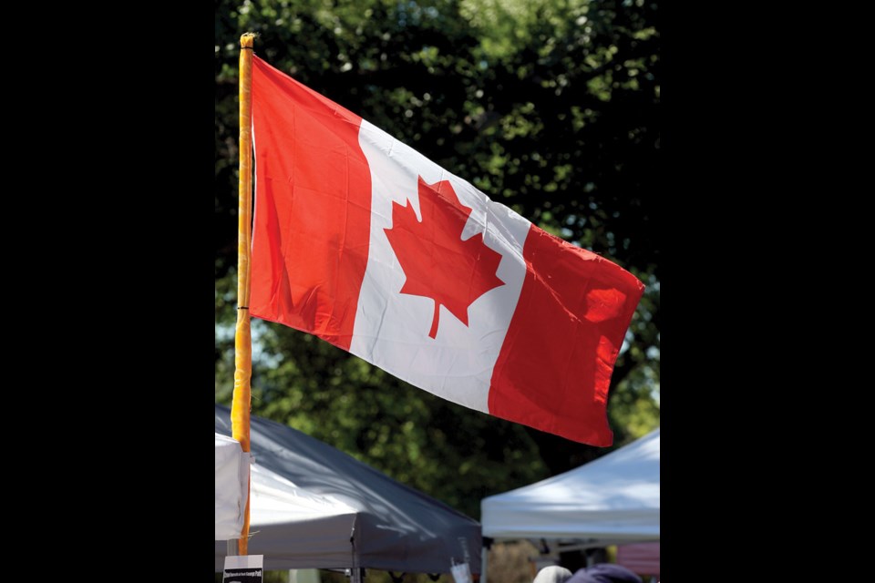 A Canadian flag waves in the breeze on Canada Day in Lheidli T'enneh Memorial Park.