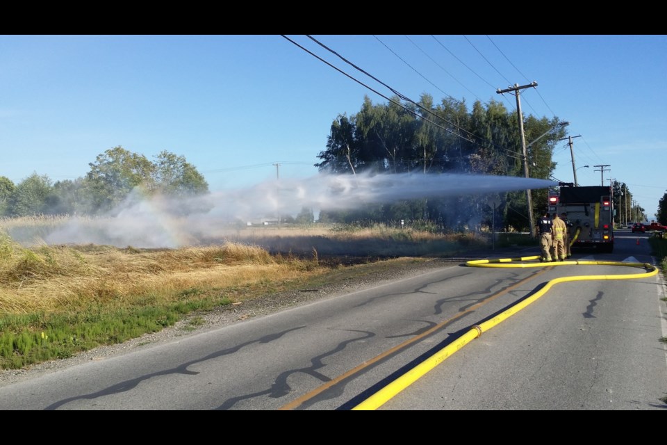 A brush fire on No. 3 Road, July 4, 2015. Photo by: Graeme Wood / Richmond News