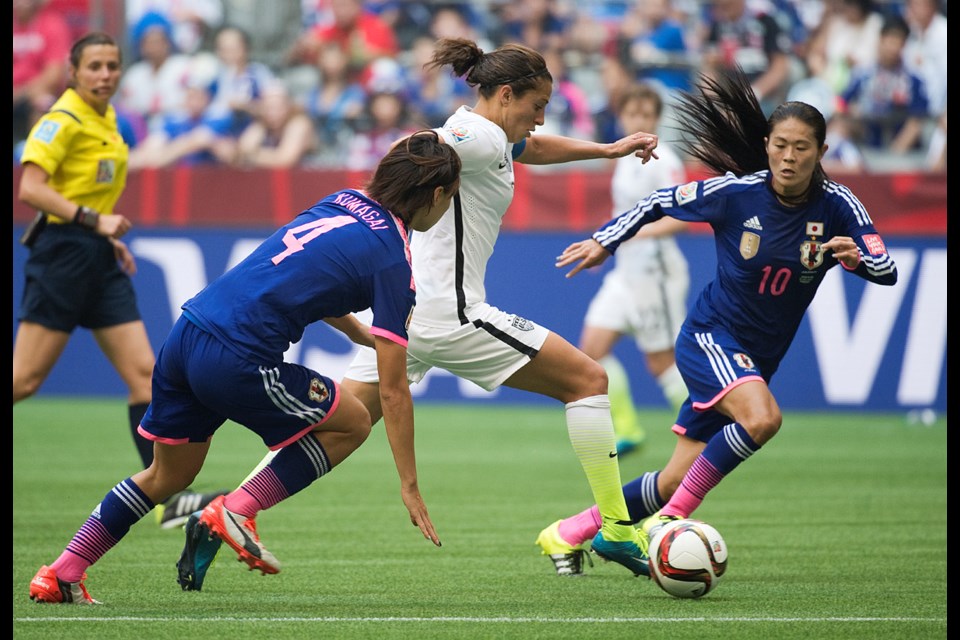 U.S. midfielder Carli Lloyd (No. 10) cuts between Japan’s Homare Sawa (No. 10) and Saki Kumagai (No. 4) in the FIFA Women’s World Cup Final at B.C. Place July 5, 2015. Photo Jennifer Gauthier
