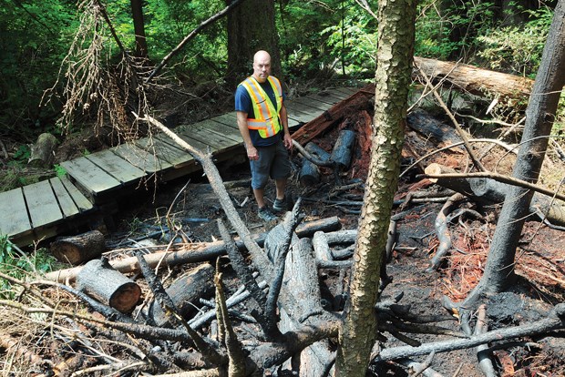 North Vancouver park ranger Andy Robinson amid the charred brush.