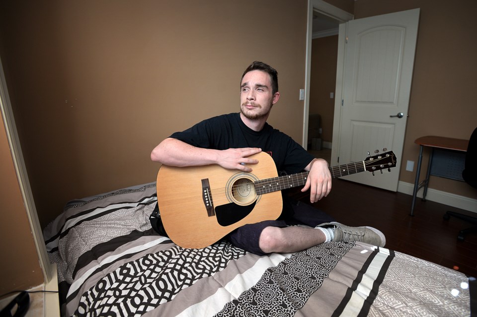 David relaxes in an apartment of his own, which RainCity helped him secure under its LGBTQ2S youth h