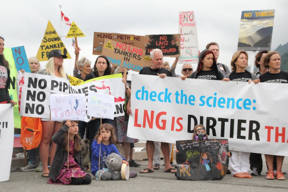 Protesters gear up for a the boat ride to the north side of Bowyer Island where they waved banners and honked in unison to state their objection to the Woodfibre LNG project.