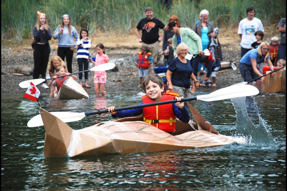 Tyler paddles his team’s cardboard kayak to victory.