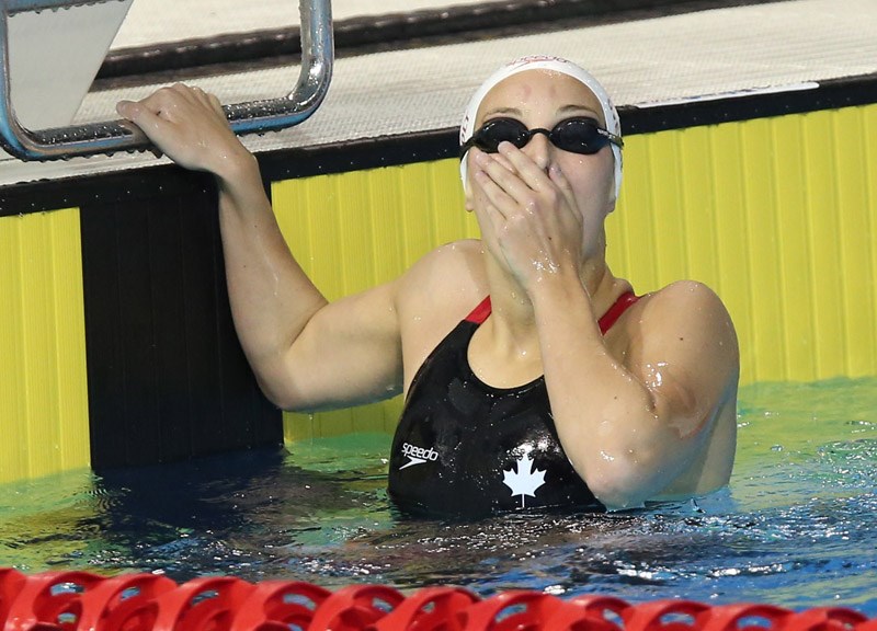 West Vancouver 17-year-old Emily Overholt reacts with shock and joy after finishing first in the women's 400-metre individual medley final at the Pan Am Games Thursday. Her joy soon turned to disappointment, however, when she was disqualified by a judge who ruled she made an illegal turn.