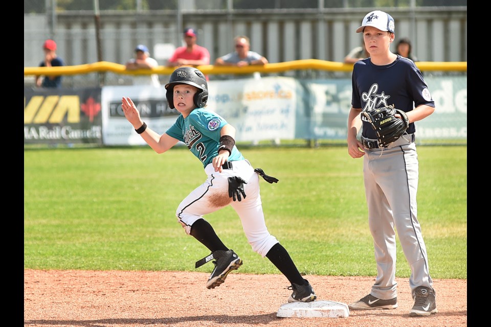 White Rock base-runner Nathan “Natty Boy” Kirkpatrick (No. 2) and Little Mountain’s second baseman Keegan Lott (No. 33) watch the play at the plate at Memorial Park South on July 22, 2015. Photo Dan Toulgoet