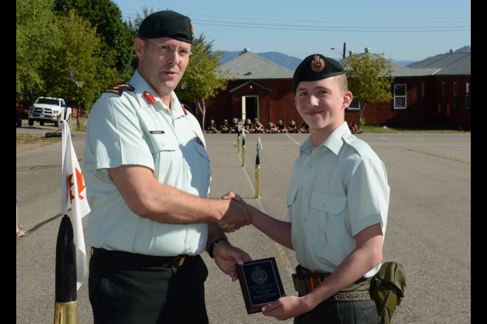 Reviewing Officer Colonel Matthew Haussmann presents Cadet Jonathan Keyton with his award as the Best Cadet in 12 Platoon at the Graduation Parade for the first intake of General Training cadets at Vernon Army Cadet Summer Training Centre.