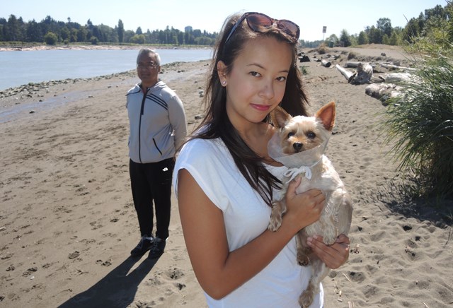 Brigitte Malana, her dad, Michael, and her Yorkie-poo, Oscar, return to the scene of Sunday evening’s attack on McDonald Beach. Malana claims Oscar was mauled by a German shepherd belonging to a woman calling herself Vanessa.