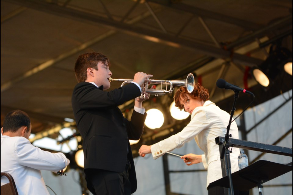 Ben Parker performs during Sunday's Symphony Splash with Tania Miller looking on