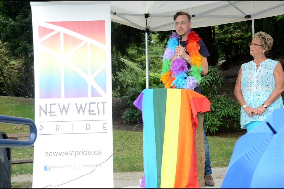 New West Pride president Jeremy Perry addresses the crowd at city hall Monday during a Pride flag raising ceremony as New Westminster MLA Judy Darcy looks on.