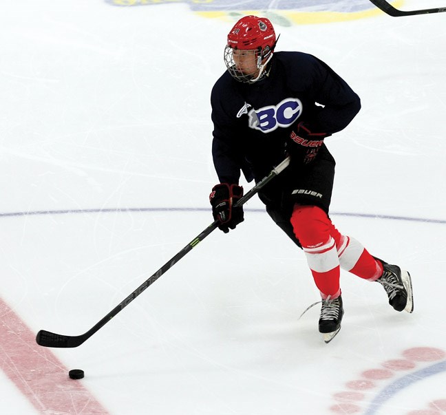 Tyler Ho skates up the ice as Team Gray (navy) took on Team Epp (white) Saturday during a scrimmage at the Cariboo Cougars training camp at the Coliseum. Team Epp won the scrimmage 2-1.