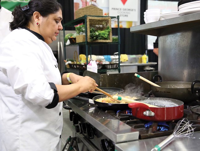 Chef Jagdish Gill of Karahi King, preparing her dishes during Saturday's Iron Ore Chef challenge at the Northern Taste Market at the BCNE.