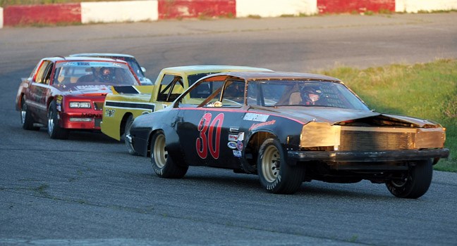 The No. 30 car of Jeremy Wickes leads the pack around the track during qualifying heats for the Twin Rivers Tri-Cities Street Stocks Invitational held on Saturday at PGARA Speedway.