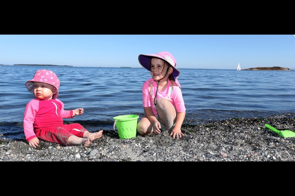 Anna, 1, and Quinn O'Connor, 4, prove that kids need little more than water and sand to fashion a good time.