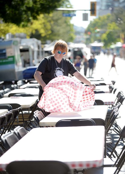 Getting set up: Volunteers like Wesley Sabiston helped the Downtown New Westminster Business Improvement Area with setup at third annual food truck festival.