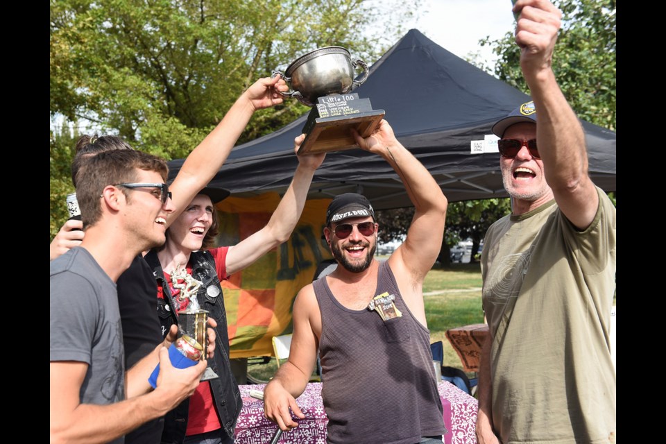 Team “Eight Ball” celebrates its win along with Little 100 race founder Rod “Pappy” Kirkham (far right). Kirkham also shares organizing duties with friends and fellow cruiser bike enthusiasts Jack McKay and Holly Paddon. Photograph by: Rebecca Blissett