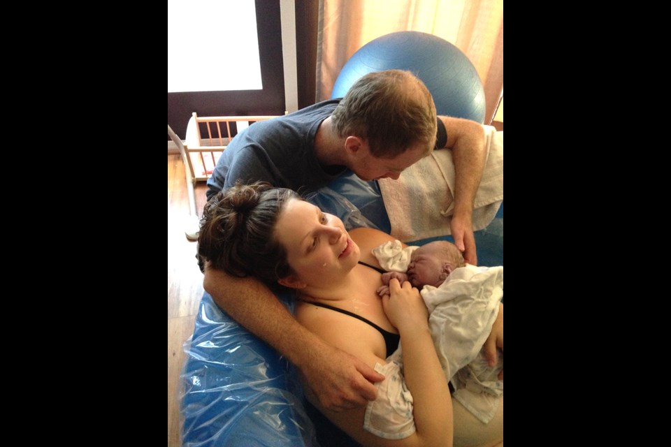 Kati and Morgen McGaw in a tender moment after the home birth of their son, Emmett.