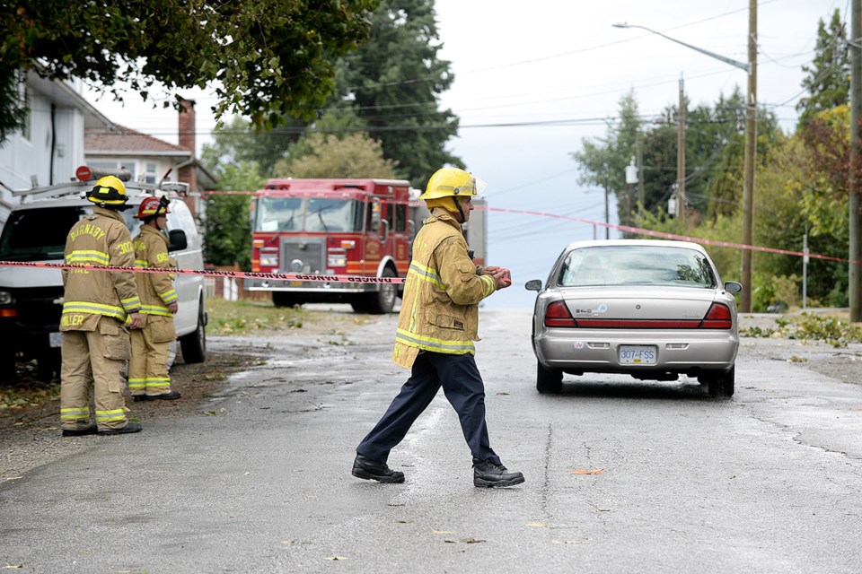 On the job: About 15 extra firefighters were called in to work on the weekend to handle the influx of calls to the Burnaby Fire Department. Most calls were for downed trees that had struck power lines.