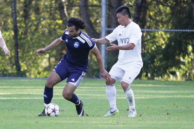 Kam Amini of the Capilano University men’s soccer team holds off a defender in a 6-1 exhibition win over West Van FC’s U21 team Aug. 24 at Capilano. The Blues are relying on an influx of North Shore talent to end a four-year playoff drought.