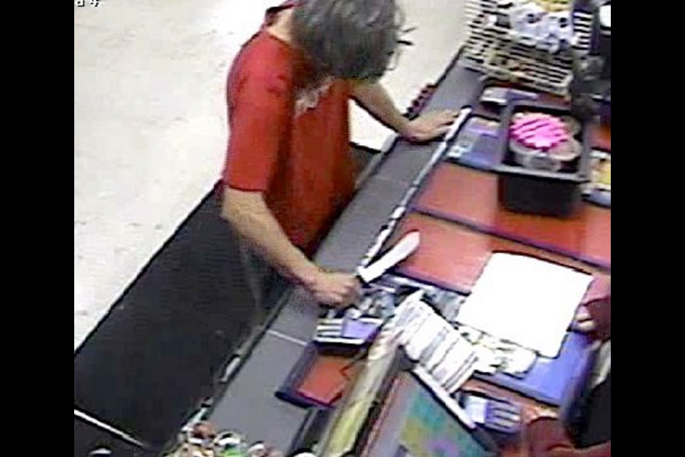 A man wearing a red Hurley T-shirt entered a 7-Eleven store on Terminal Avenue in Nanaimo on Aug. 13, 2015. After brandishing a knife at the clerk, he escaped on foot.