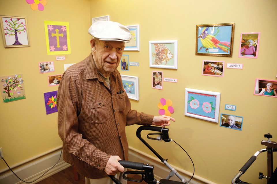 Alf Ernstedt views artwork at the newly opened art gallery at Royal City Manor. The facility has found that art therapy improves residents’ quality of life.