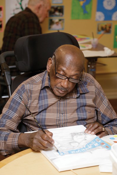 Mozart Mimms sketches at Royal City Manor, where some of his artwork is displayed at the newly opened art gallery. The facility has found that art therapy improves residents’ quality of life.
