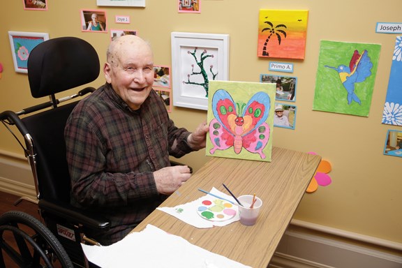 Joseph Woutowitsch with his artwork at the newly opened art gallery at Royal City Manor. The facility has found that art therapy improves residents’ quality of life.