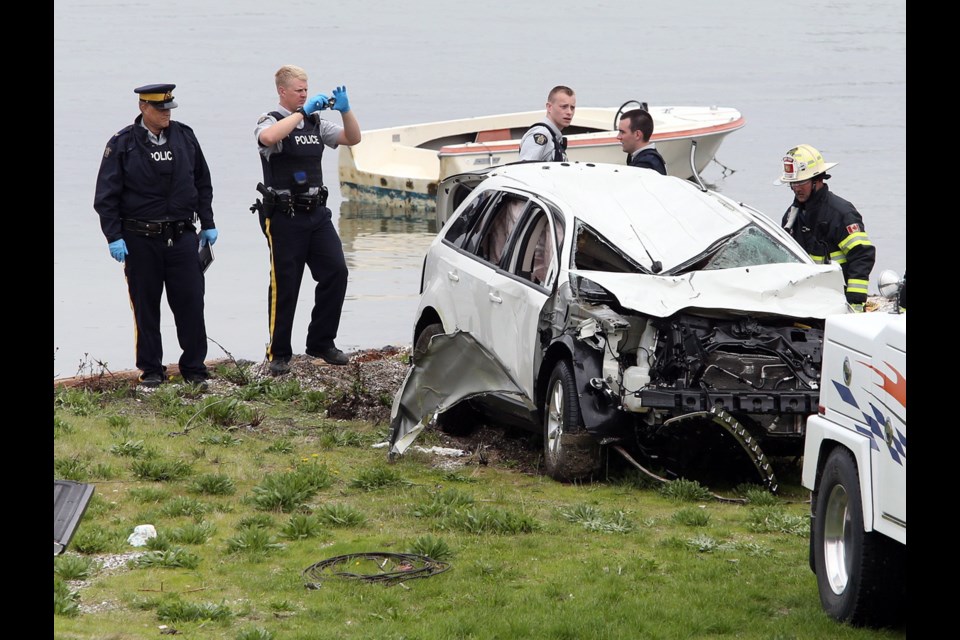 A white SUV was pulled from the water near the Mill Bay ferry terminal Friday afternoon, about seven hours after it sped down the trestle and launched off the ramp. Sept. 18, 2015