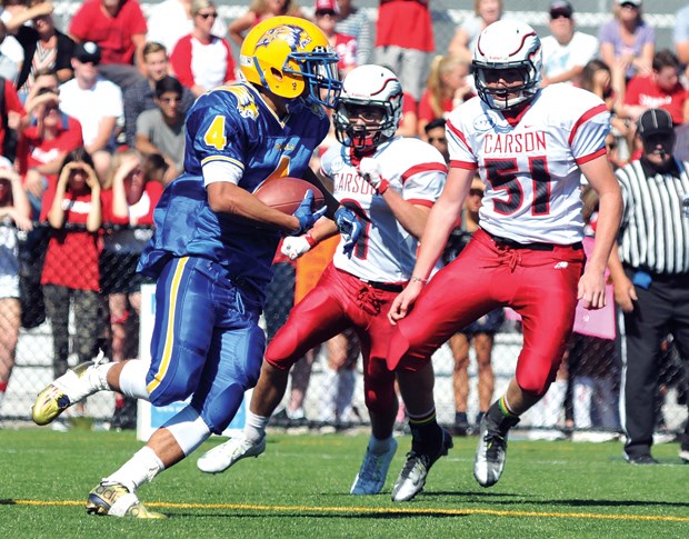Handsworth running back Leon Kyoyo takes on a pair of defenders during a 21-20 win for the visiting Royals in Buchanan Bowl 29 played Sept. 12 at Carson Graham. Kyoyo racked up 110 yards to help seal the win for Handsworth.