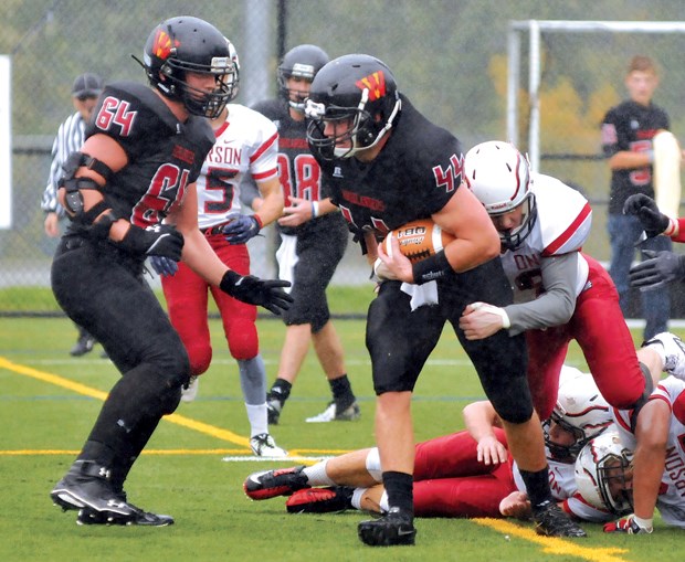 West Vancouver’s Riley Burns churns out some tough yards during an 8-0 exhibition loss against the Carson Graham Eagles Saturday at Carson. The West Van program has received a boost from some recent grads who have come back to coach.