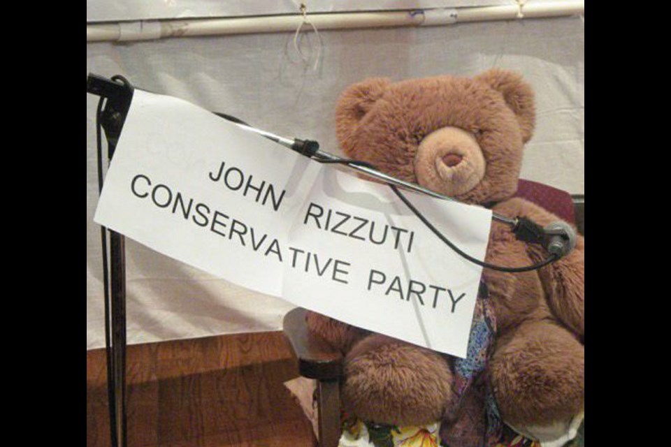 A teddy bear wearing a tie was put in the place of Victoria Conservative candidate John Rizzuti at an all-candidates meeting in Victoria on Monday.