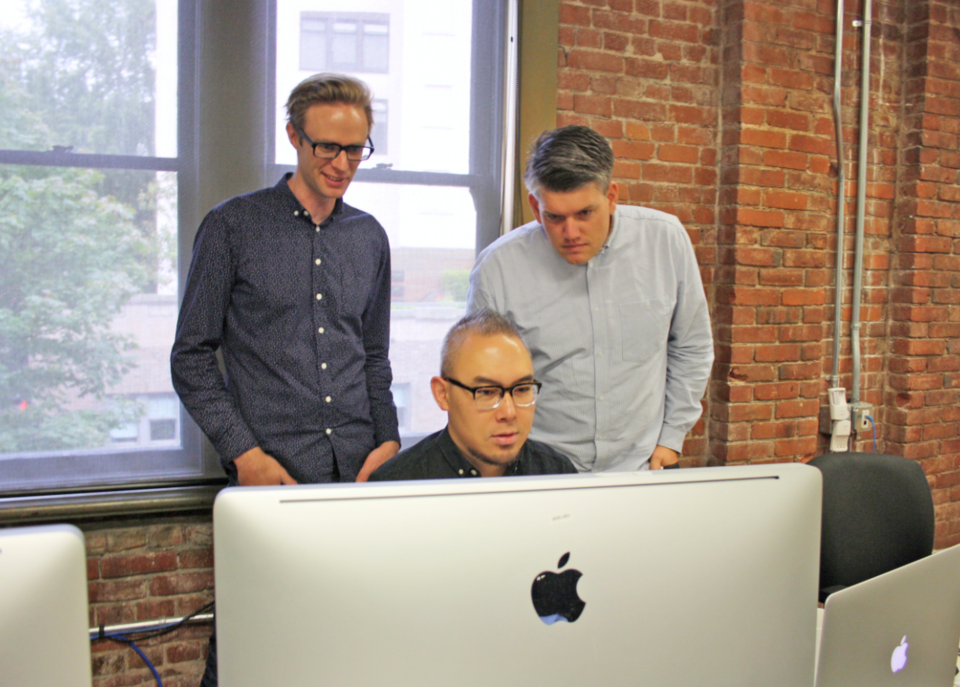 Invoke Media head of strategy Duncan Blair, left, works with lead designer Dominic Wong