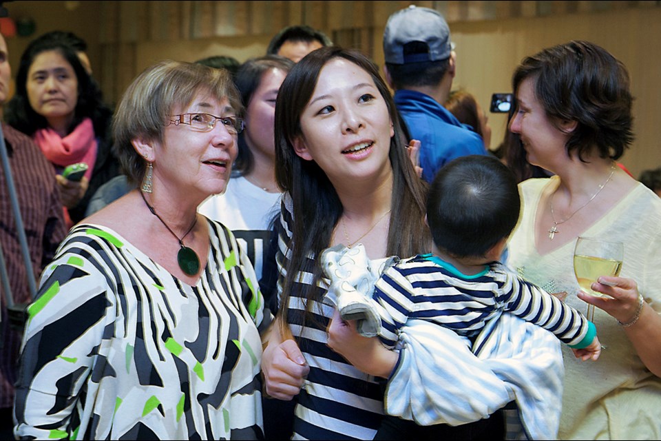 First-time mom and Burnaby school board trustee Katrina Chen, centre, holds her son Yoann during a victory party after the 2014 municipal elections.