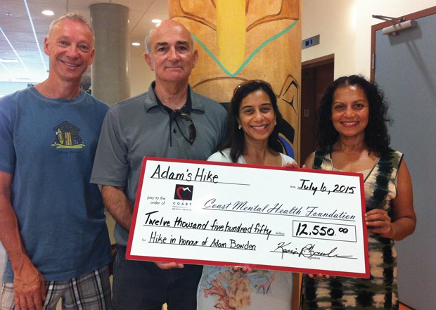 Family members Gary Matich, Kevin Bowden, Femina Matich and Melina Bowden display a $12,550 cheque for Coast Mental Health. The money was raised at a walk to honour Adam Bowden in June, which started at the Gleneagles Community Centre and finished at Whyte Lake and drew 250 people.