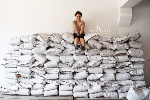 Shaunti Bains, a 16-year-old from North Vancouver, sits atop a mountain of soy beans. The teen visited North Korea this year after spending most of her life helping to raise money to combat malnutrition in North Korean children. photo supplied, First Steps