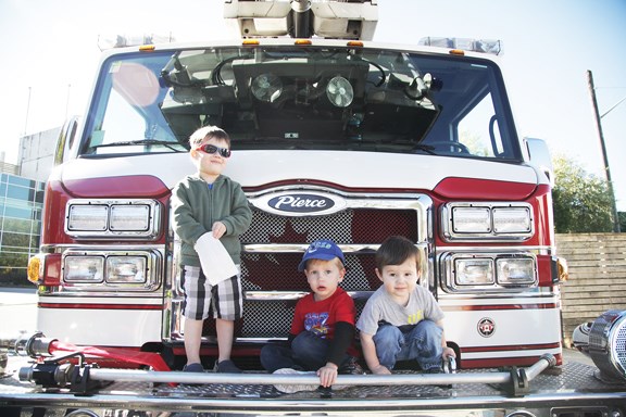 Dylan, 4 Liam,3 and Thomas Folka, 2 pose on the fire truck at the New Westminster Fire and Rescue Services' 2015 open house.