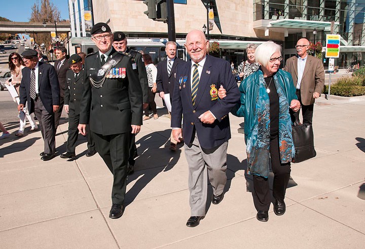 Warren "Whitey" Bernard and his wife Ruby, centre, walk to Hyack Square after a reception at Anvil Centre. Bernard is the little boy in the photograph taken by Province photographer Claude Dettloff 75 years ago.